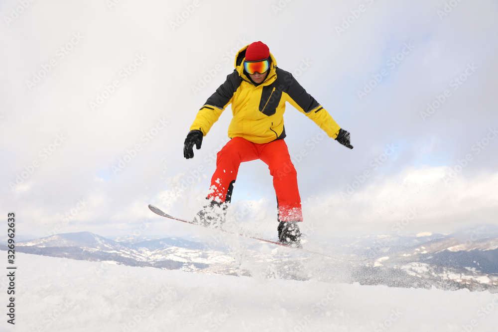 Male snowboarder on snowy hill. Winter vacation Male snowboarder on snowy hill. Winter vacation