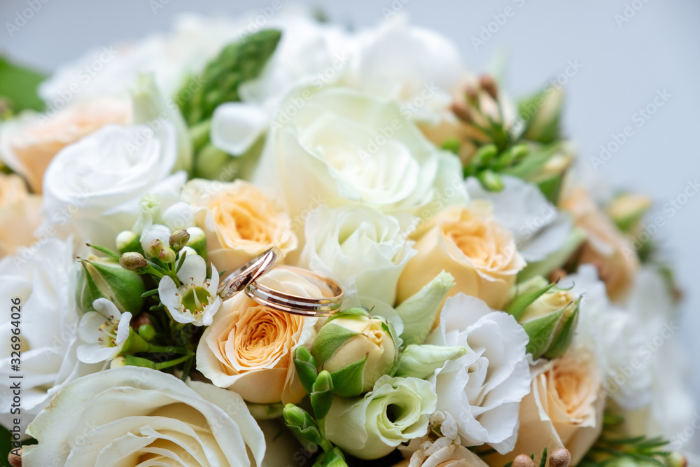 wedding rings are on the wedding bouquet