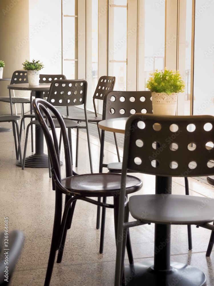 Fototapeta premium Simple retro style coffee shop interior with white and black chairs