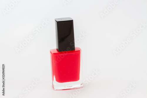 red nail polish bottle on white background