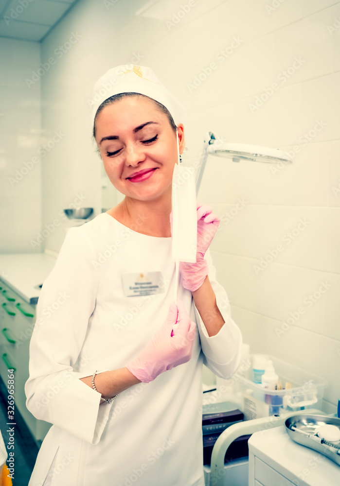 Young smiling brunette woman doctor, nurse, cosmetologist, chemi Young smiling brunette woman doctor, nurse, cosmetologist, chemi