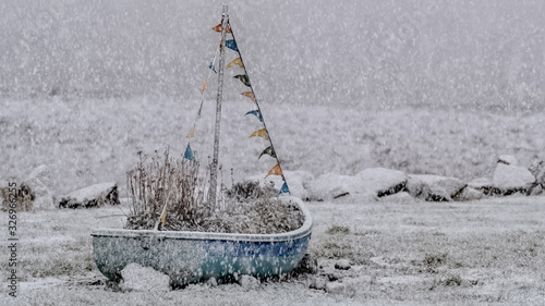 Boat memorial in winter snow storm at Brora in the Highlands of Scotland photo