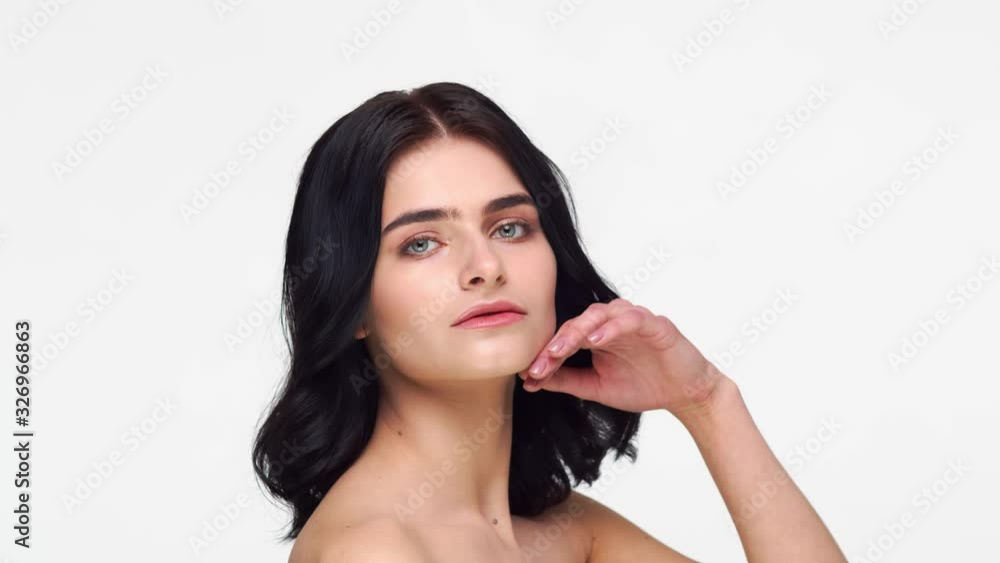 Studio portrait of young and beautiful brunette woman over isolated white background. Skin care, health, makeup and cosmetics. Studio portrait of young and beautiful brunette woman over isolated white background. Skin care, health, makeup and cosmetics.