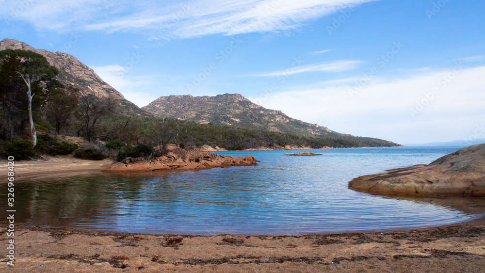Crystal clear calm sea at Wineglass bay in Tasmania Australia