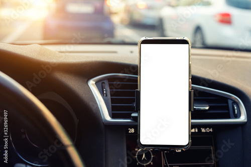 фотографія Modern smartphone device gadget mounted on phone holder at car dashboard