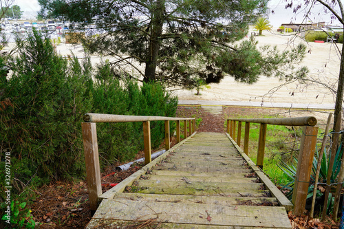 wooden stairs sand beach access to Biscarrosse lake in south west France photo