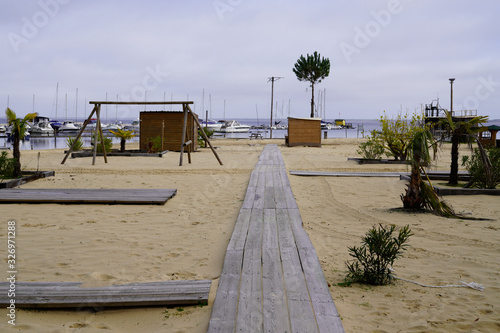 Wooden pathway boards to Biscarrosse beach lake sea in landes France photo