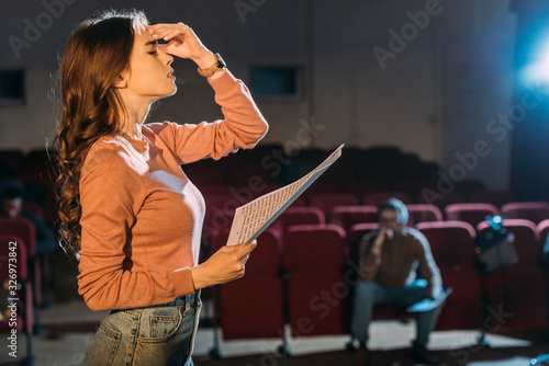 Fotografie Selective focus of theater director and actress with screenplay on stage
