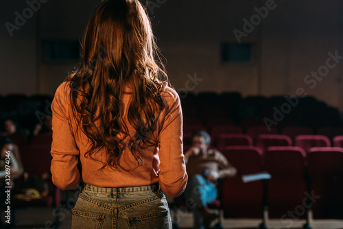 back view of actress and stage director in theater photo