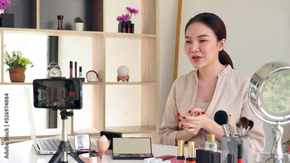 4k video of Famous blogger. Cheerful female vlogger is showing cosmetics products while recording video for everyday makeup tutorial. at work. 4k video of Famous blogger. Cheerful female vlogger is showing cosmetics products while recording video for everyday makeup tutorial. at work.