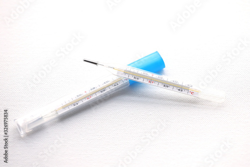 Thermometer and pills isolated on a white background.