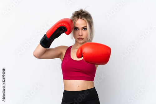 Teenager girl holding waffles over isolated blue background with boxing gloves