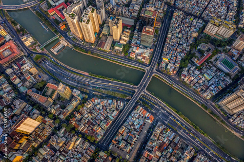 Aerial panoramic cityscape view of HoChiMinh city and the Nhieu Loc canar , Vietnam with blue sky at sunset.  photo