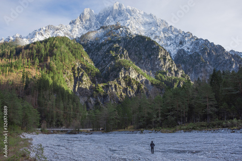 Man looking at high mountains in The Gesause National Park, Styria region, Austria photo