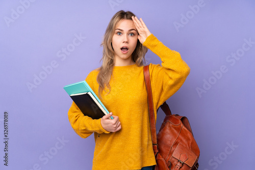 Teenager Russian student girl isolated on purple background with surprise expression