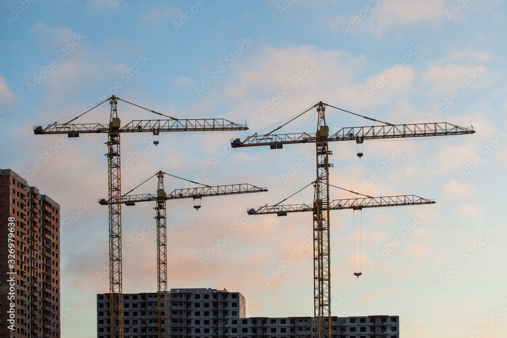 construction site with cranes against the blue sky	