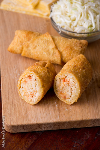 Egg rolls or spring rolls fried.Traditional Chinese Thai restaurant appetizer, spring rolls or egg rolls. Made from wonton wrappers and filled with Chinese veggies and served w/ chili dipping sauce.