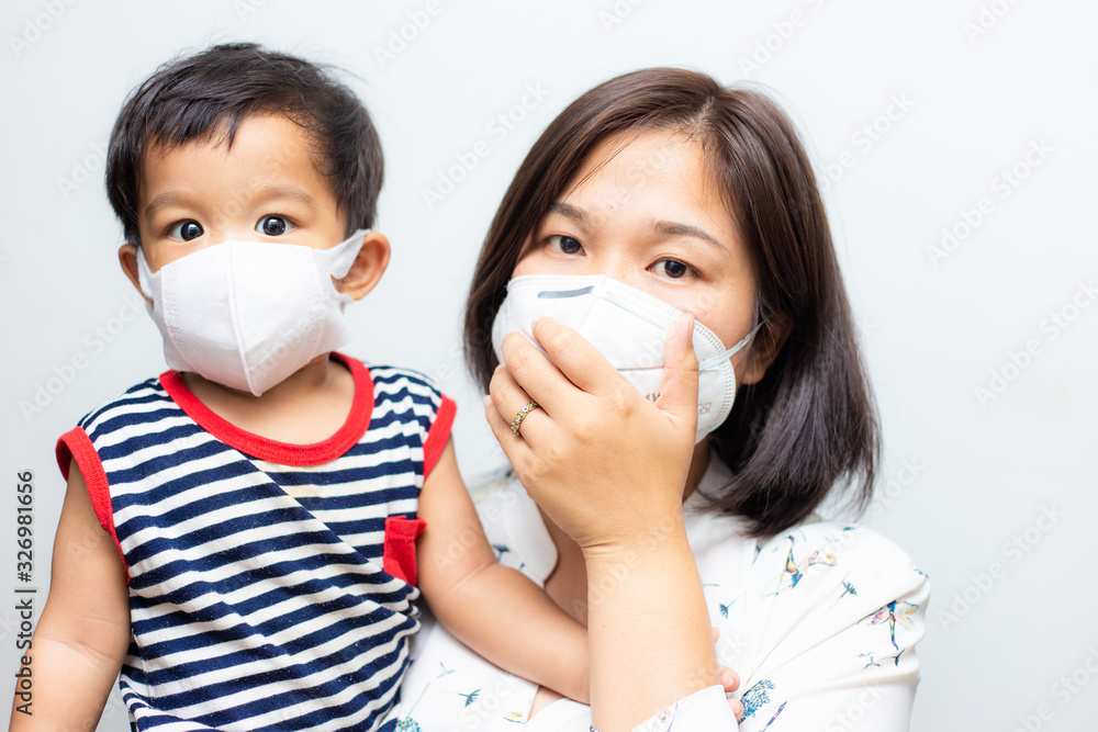 Asian mother carry baby boy wear mask protect pm2.5 and COVID-19 outbreak