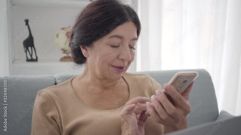 Close-up of happy elegant Caucasian woman using smartphone. Portrait of smiling middle-aged brunette woman with brown eyes surfing Internet or using social media. Lifestyle, leisure, joy. Close-up of happy elegant Caucasian woman using smartphone. Portrait of smiling middle-aged brunette woman with brown eyes surfing Internet or using social media. Lifestyle, leisure, joy.