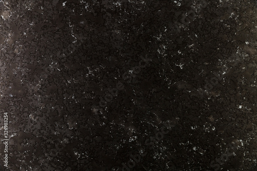 Dark concrete wall with coarse surface