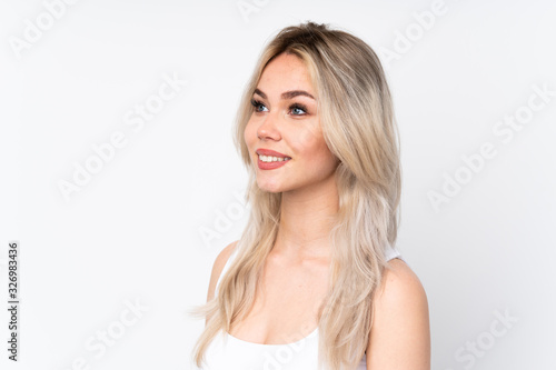 Teenager blonde girl over isolated white background . Portrait