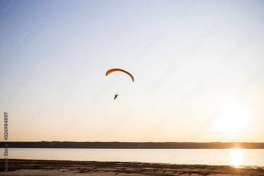 Paraglider fly, sunset time.