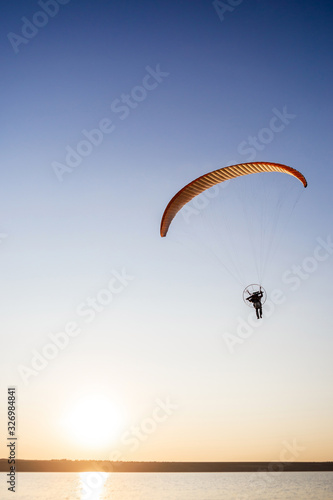 Paraglider fly, sunset time.