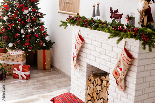 The Christmass tree stands near presents