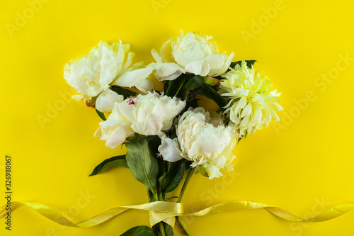 Beautiful peony flowers closeup over textured background with a lot of copy space for text. International women s mother s valentine s first spring day. Close up  top view  backdrop  flat lay.