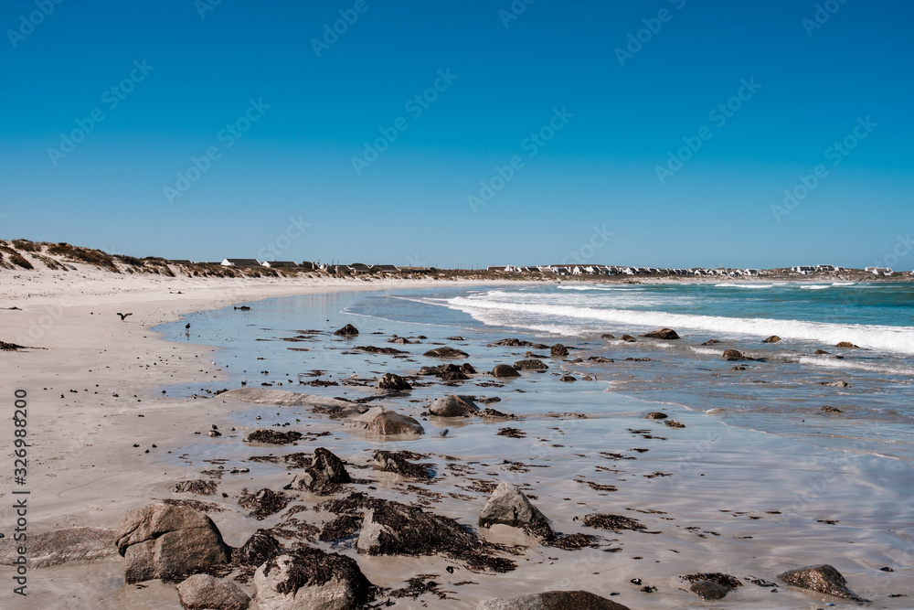 Natural long beach in Africa with waves and stones Natural long beach in Africa with waves and stones