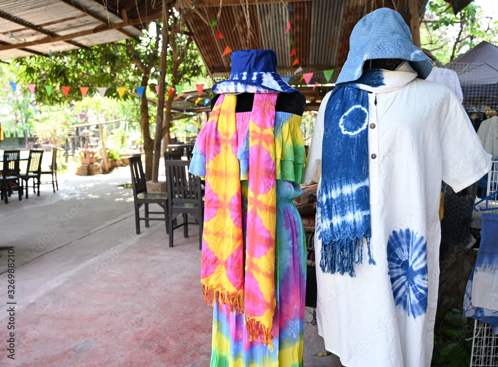 Community products made from dyed fabrics, bright and beautiful. Produced as shirts, skirts, scarves and hats for sale in community stores in Thailand.