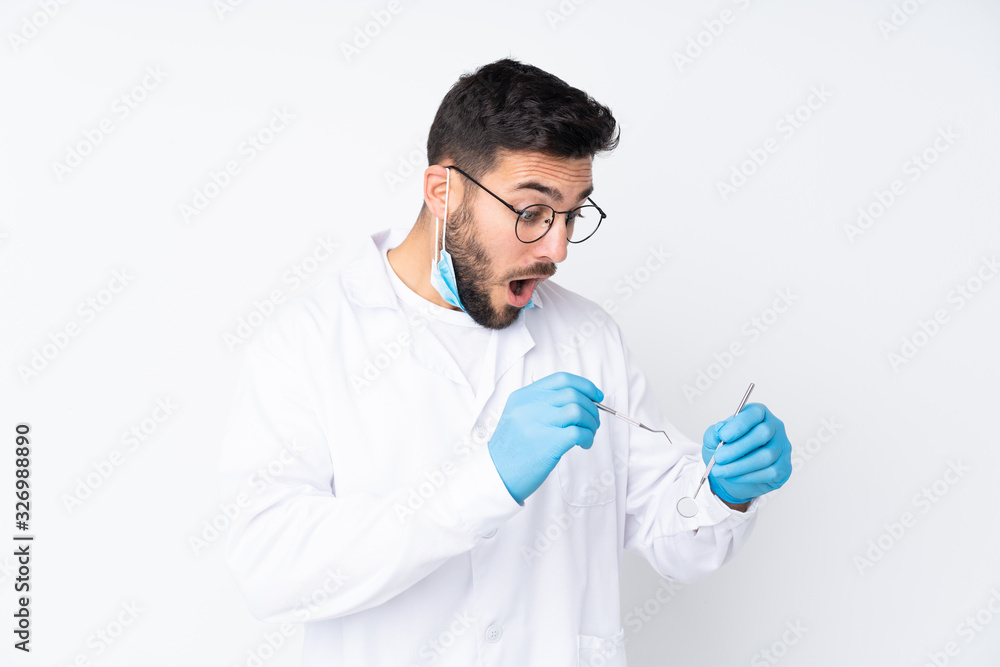 Caucasian dentist man over isolated background Caucasian dentist man over isolated background