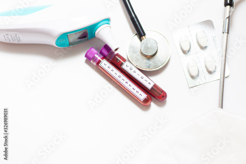 Coronavirus COVID-19 outbreak infected blood sample in sample tube laboratory analysis obkect on white background photo