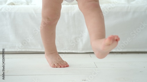 Infant Baby Steps On A Floor