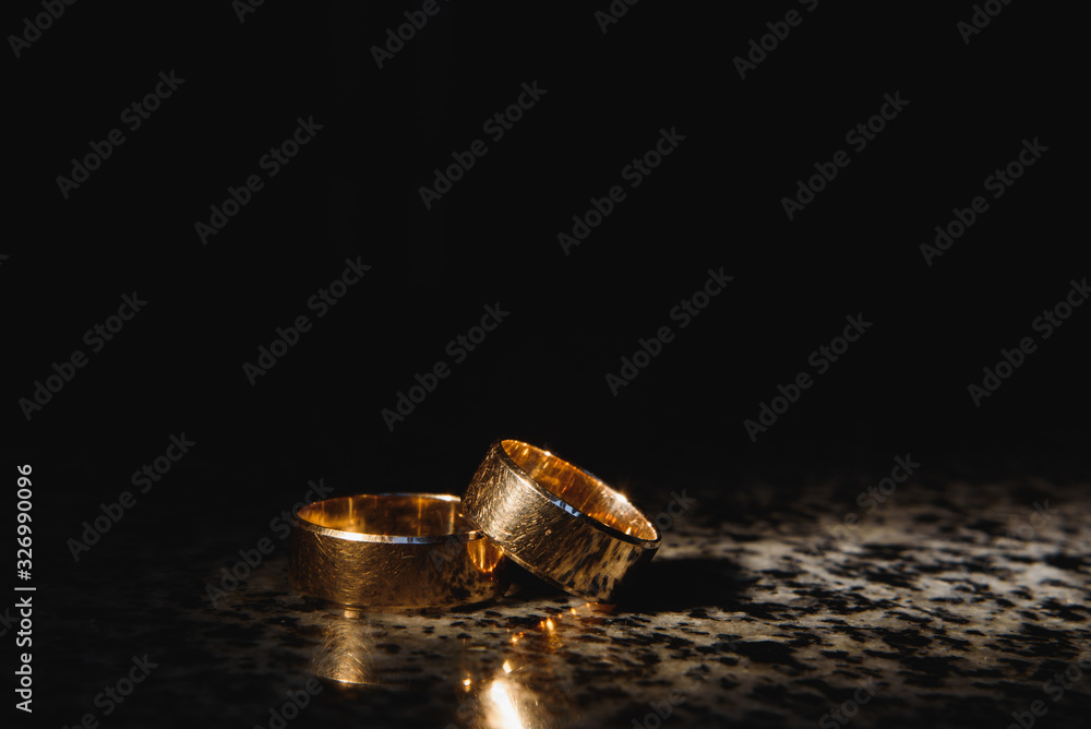 Beautiful wedding gold rings on dark background Beautiful wedding gold rings on dark background