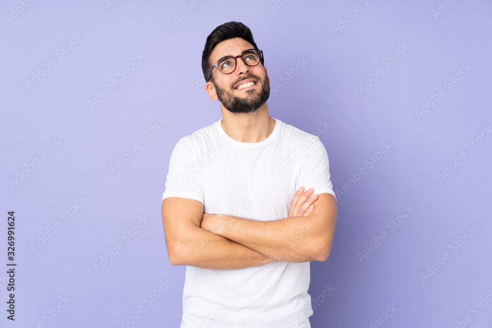 Caucasian handsome man over isolated background looking up while smiling Caucasian handsome man over isolated background looking up while smiling