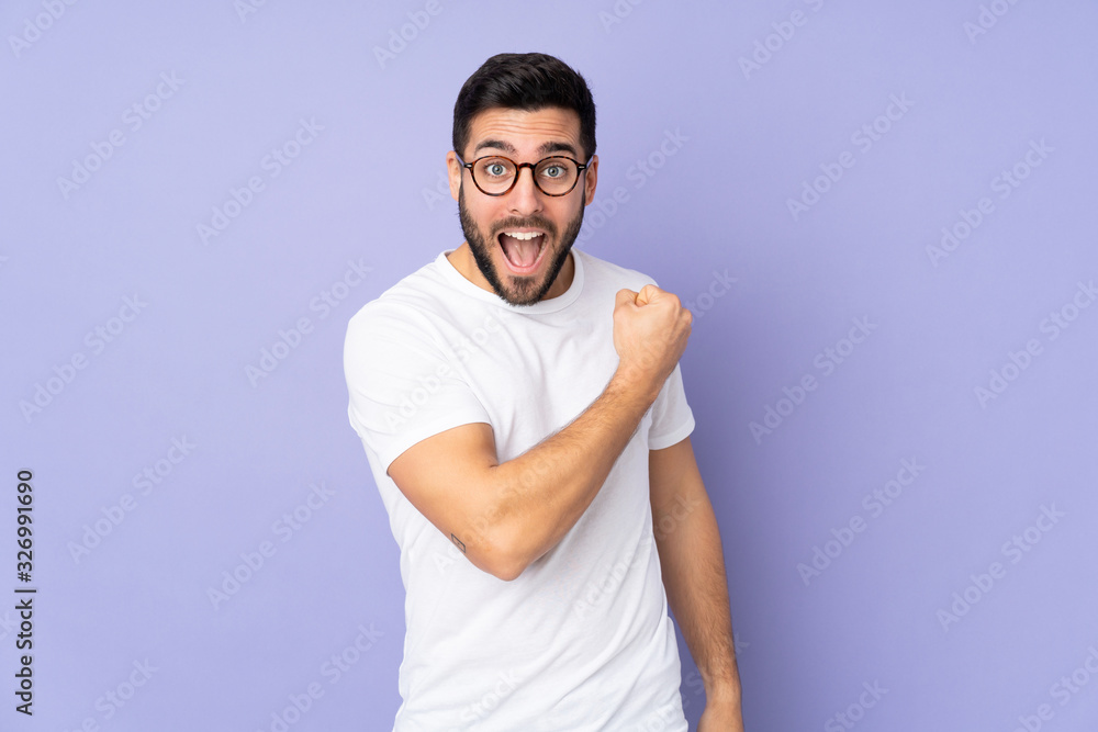 Caucasian handsome man over isolated background celebrating a victory Caucasian handsome man over isolated background celebrating a victory