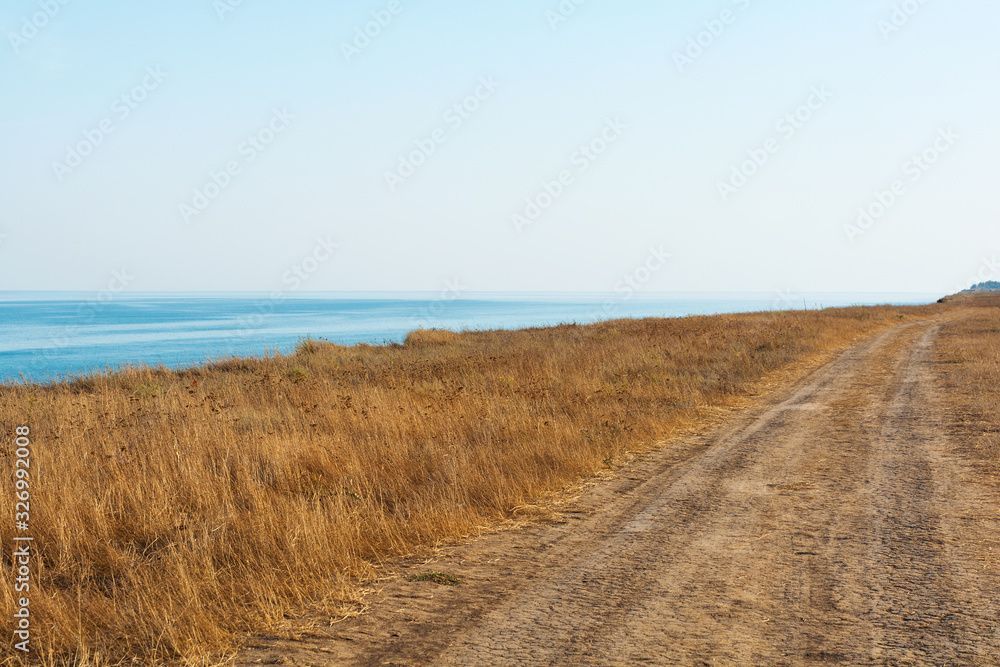 Fototapeta premium Ground road along sea. Travel concept