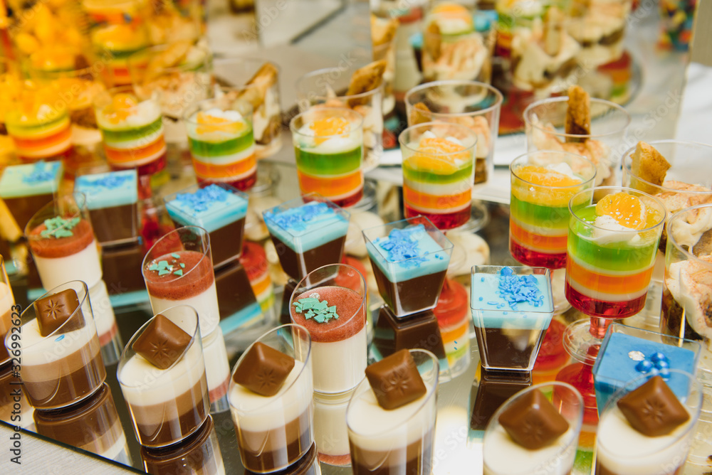 Delicious sweets on wedding candy buffet with desserts, cupcakes,tiramisu and cookies