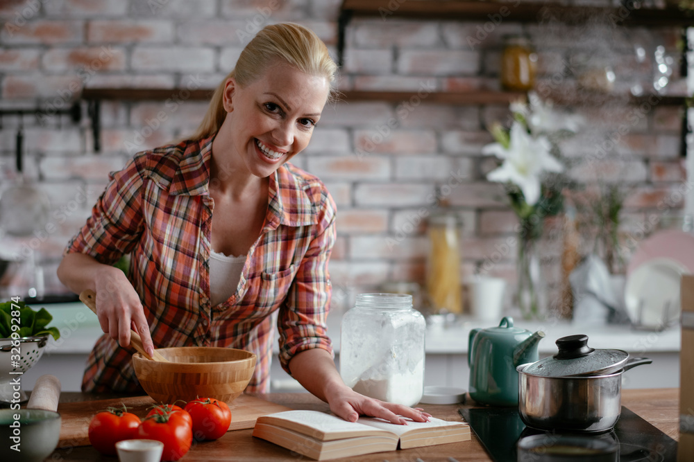 Woman in kitchen. Portrait of beautiful woman cooking. Woman in kitchen. Portrait of beautiful woman cooking.