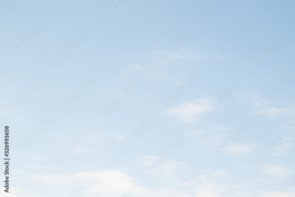 Blue sky with white clouds, nature background. Blue pastel sky, soft focus lens. Abstract blurred white blue gradient peaceful character.