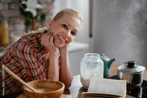 Woman in kitchen. Portrait of beautiful woman cooking. 