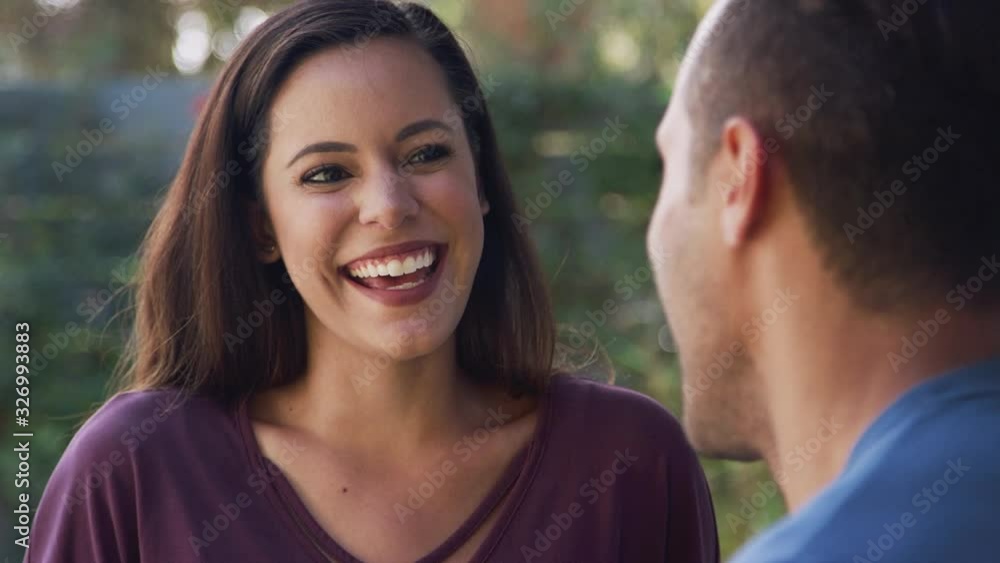 Smiling Hispanic Couple Talking And Laughing In Garden At Home Smiling Hispanic Couple Talking And Laughing In Garden At Home