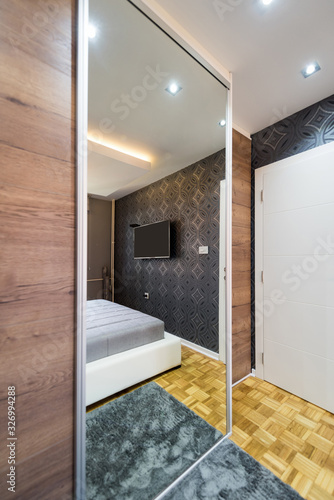 Bedroom interior with large closet mirror door