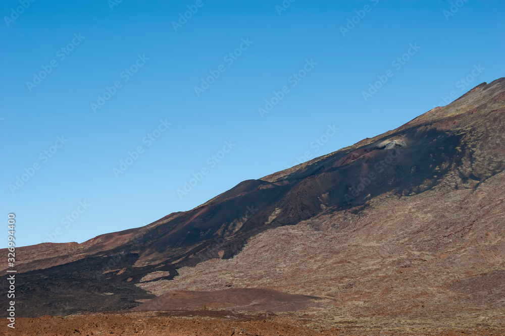 Frozen lava which was flowing down the slope of Pico Viejo. The top of the Teide volcano. Frozen lava which was flowing down the slope of Pico Viejo. The top of the Teide volcano.