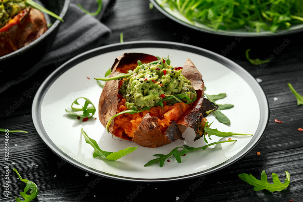 Baked Sweet potato boats stuffed with avocado guacamole and wild rocket sprinkled with nigella seeds Baked Sweet potato boats stuffed with avocado guacamole and wild rocket sprinkled with nigella seeds
