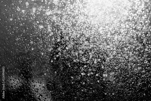 Raining on the glass off window..Black and white trend photo.