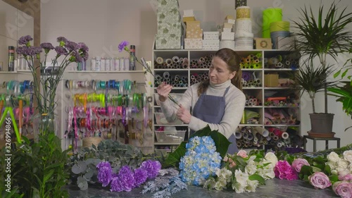 Florist prepares flowers for a bouquet