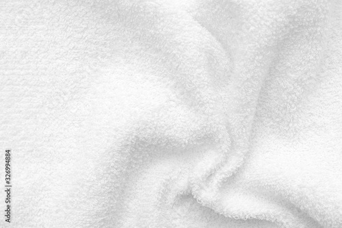 White crumpled terry fabric texture with folds. Towel texture.