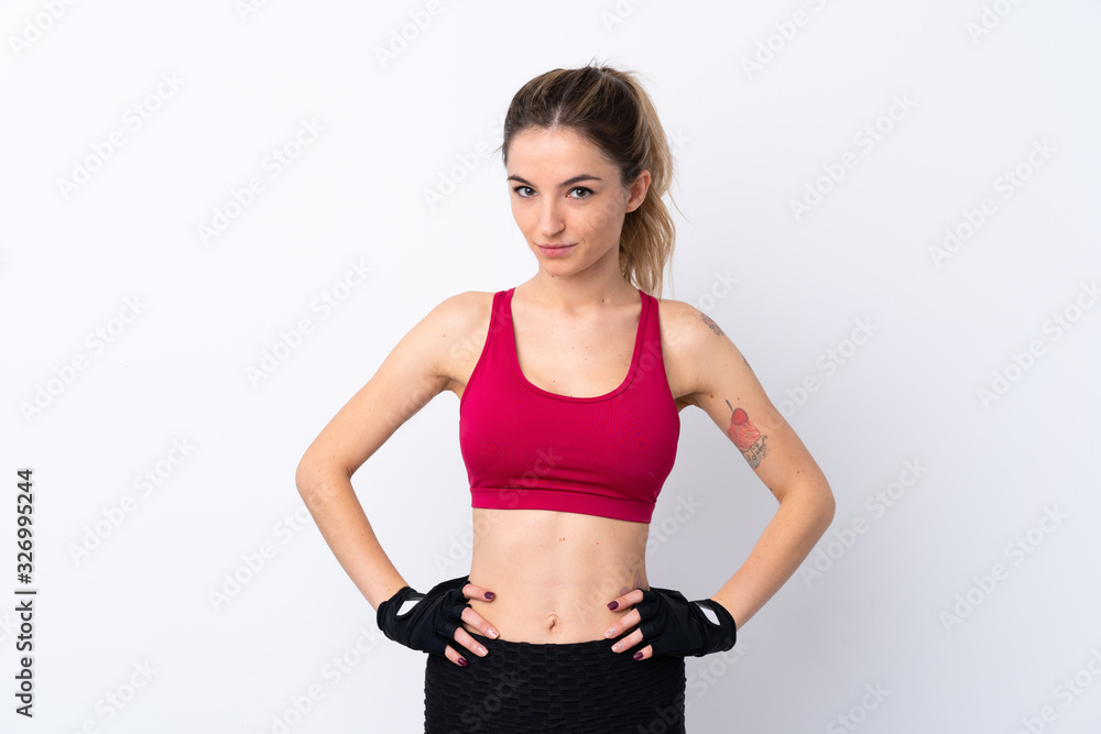 Young sport woman over isolated white background posing with arms at hip Young sport woman over isolated white background posing with arms at hip